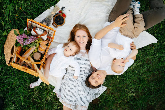Family celebrating Mother's Day picnic at the park