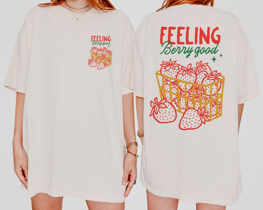 Back and front of the shirt with a basket of strawberries and a text " Feeling Berry Good