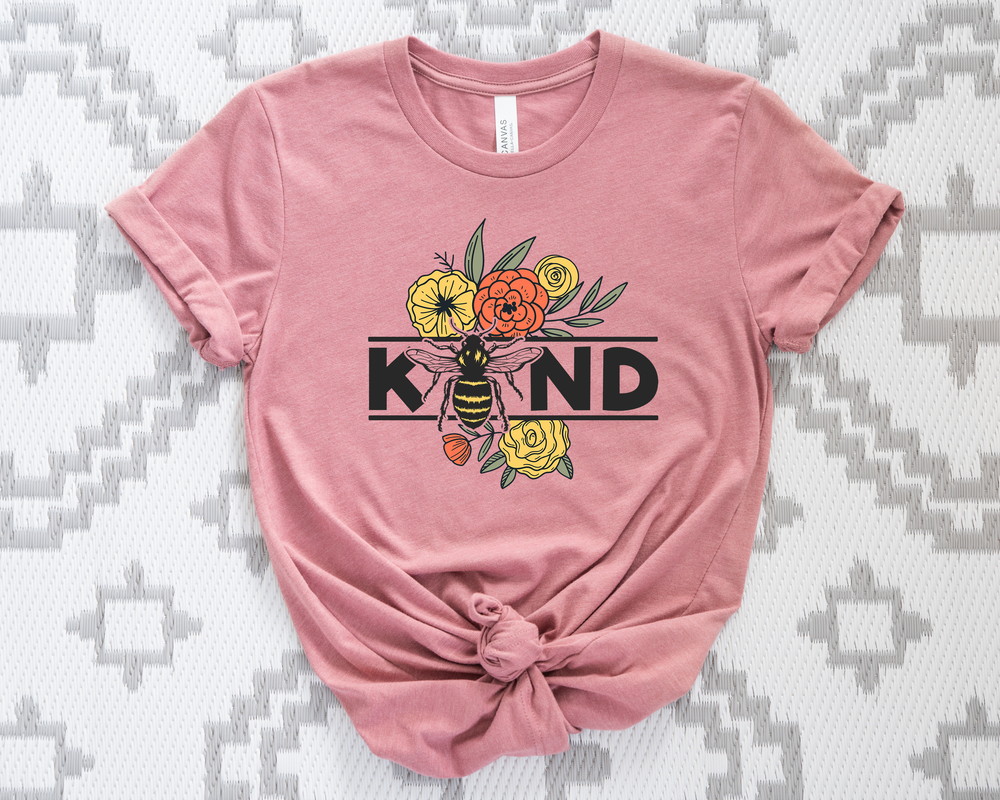 Pink t-shirt with a bee and floral design on a patterned background