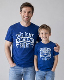 Dad is wearing a royal blue shirt with a text" This is My Garage shirt" and son wears same coloured shirt with the text " This is my Working in the Garage with dad shirt"
