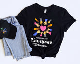Black t-shirt with 'Harmony Day Everyone Belongs' design, black cap, and jeans on a white background