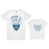 A set of two white t-shirts, one for adults and one for children, each with a Viking-themed graphic print.