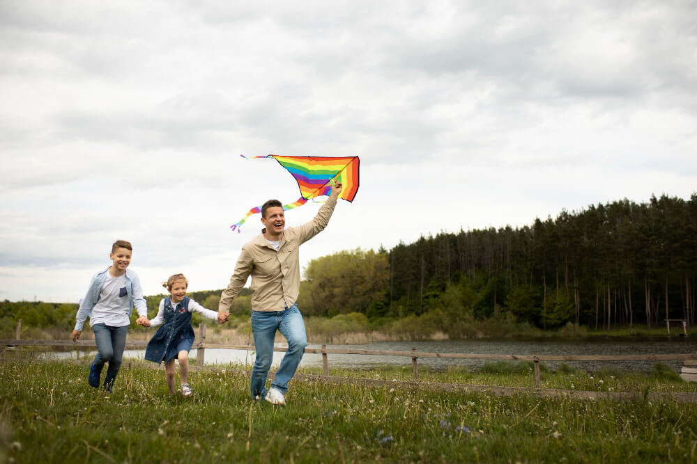 Dad and kids playing with a kite