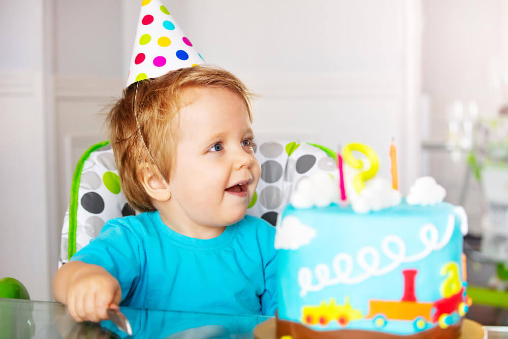 Toddler celebrating his train themed birthday
