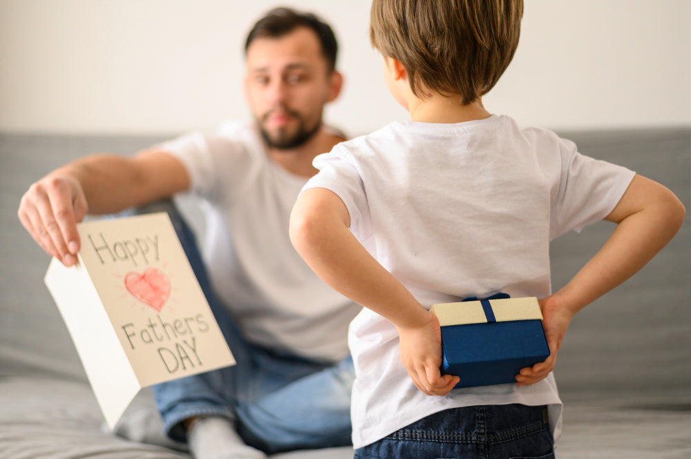 boy with a father's day gift for his father