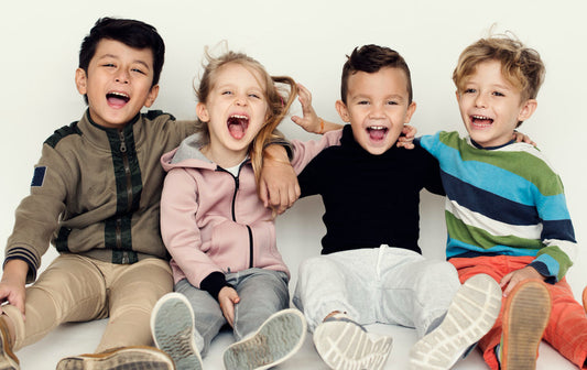 cousins happily smiling art the camera