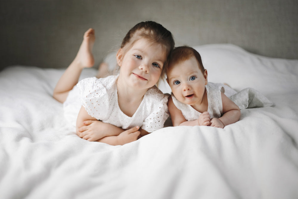 sibling bonding activities – toddler and baby spending quiet time together