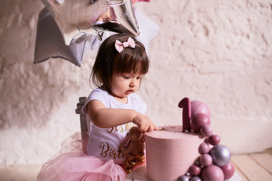 toddler enjoying her birthday cake