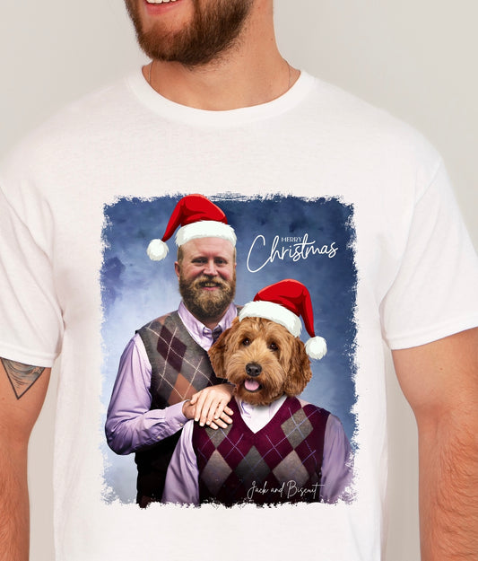 White t-shirt with a graphic of a man and dog wearing Christmas hats, with 'Merry Christmas' text.