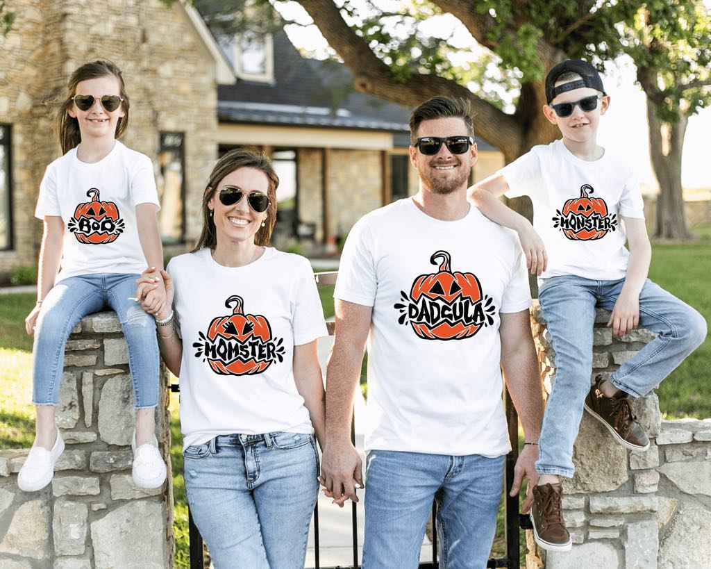 A happy family wearing matching pumpkin Halloween shirts