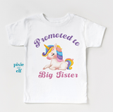 White t-shirt with a unicorn graphic and text 'Promoted to Big Sister' on a white background