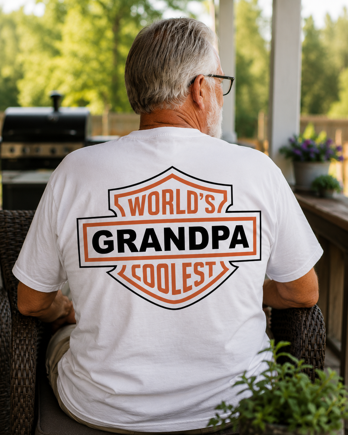Man wearing a white t-shirt with 'World's Coolest Grandpa' text on a patio.