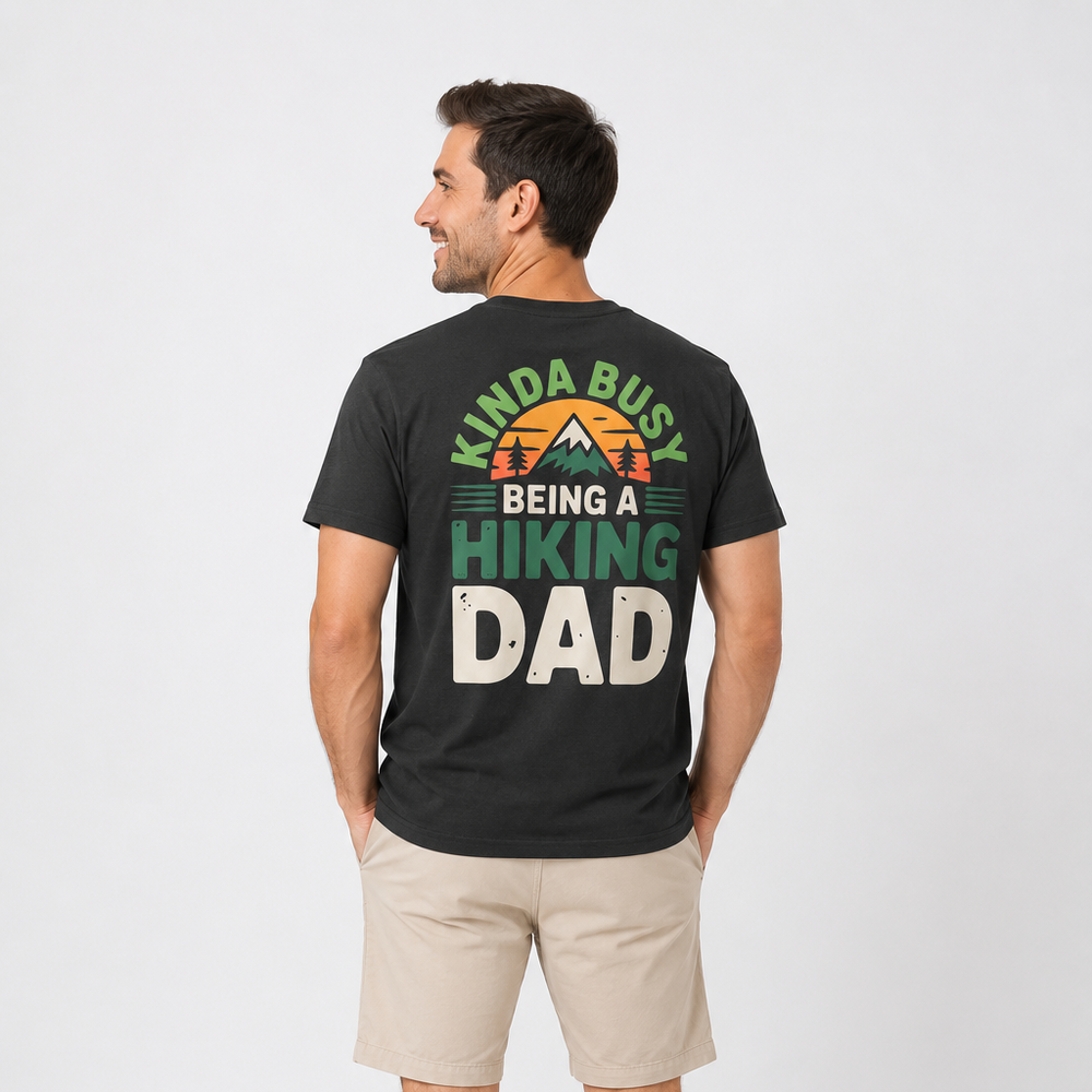 Man wearing a black t-shirt with 'Kinda Busy Being a Hiking Dad' text on a white background