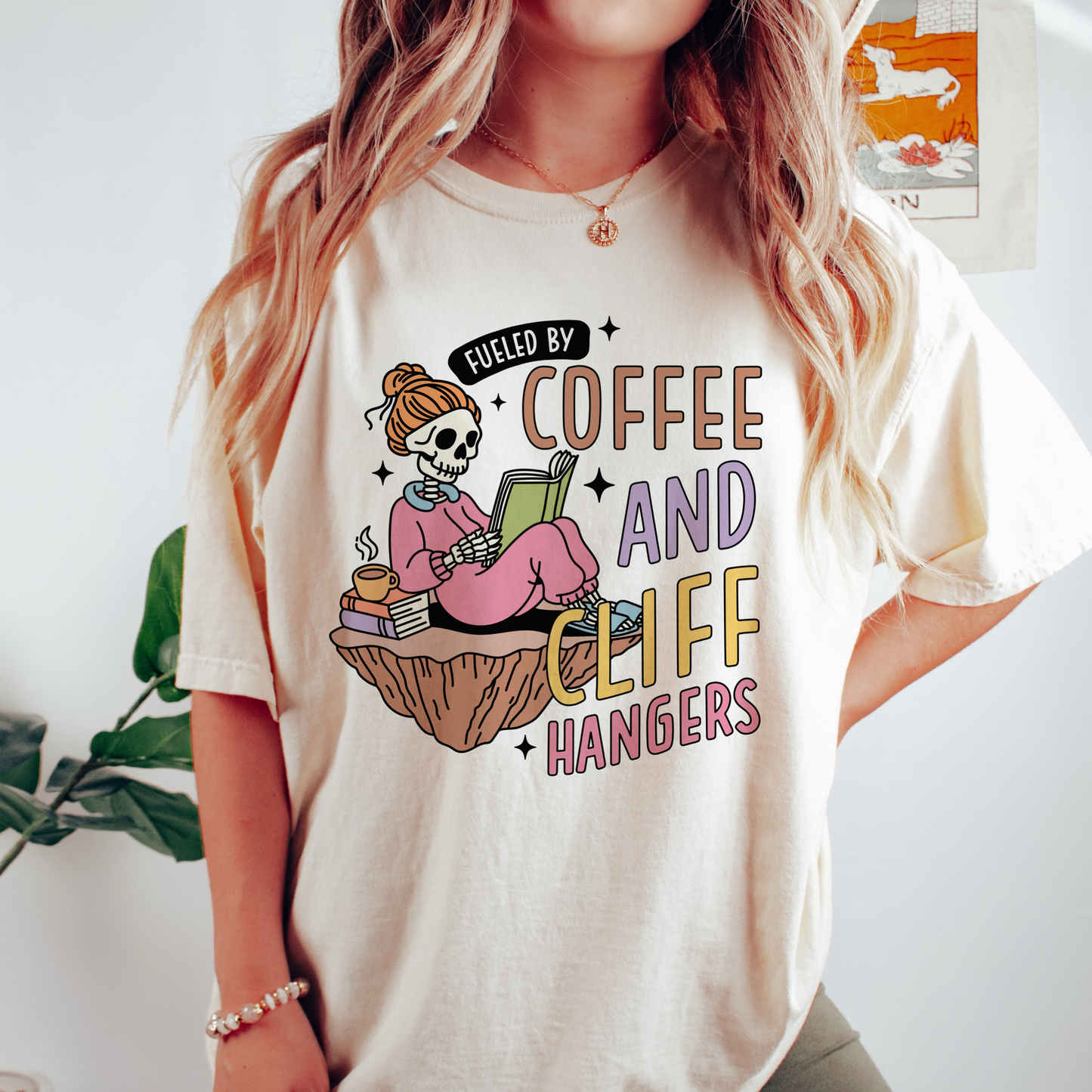 Coffee and Cliff Hangers and a skeleton dressed in pajamas printed on an Ivory Comfort Colors shirt