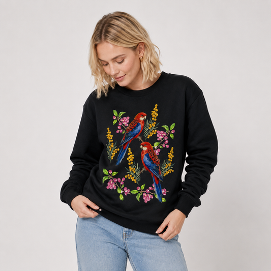 Woman wearing a black jumper with Australian Crimson Rosella birds and wattle flowers