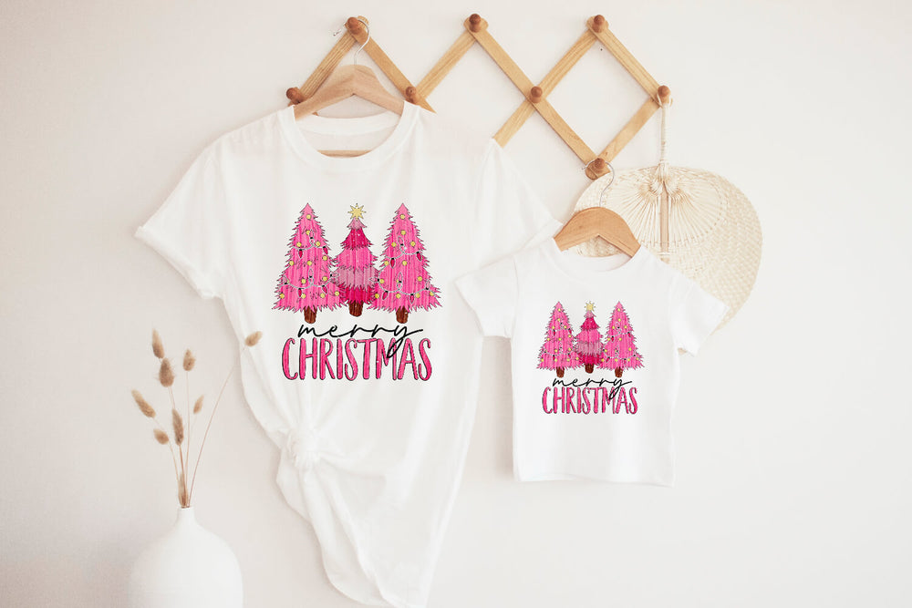 Matching adult and kid Pink Christmas T-Shirt hanging on the wall