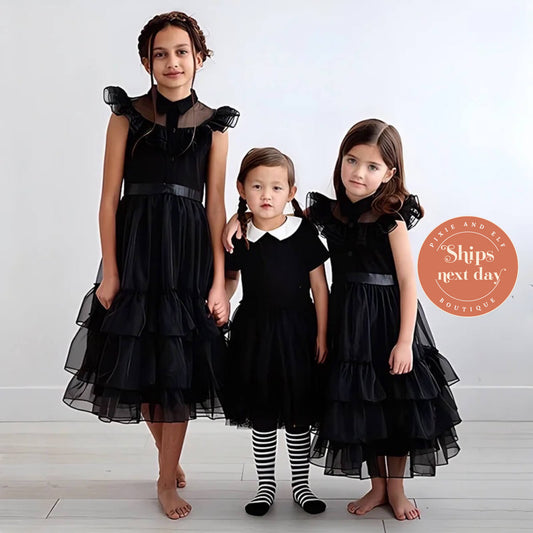 3 girls wearing Wednesday inspired dresses