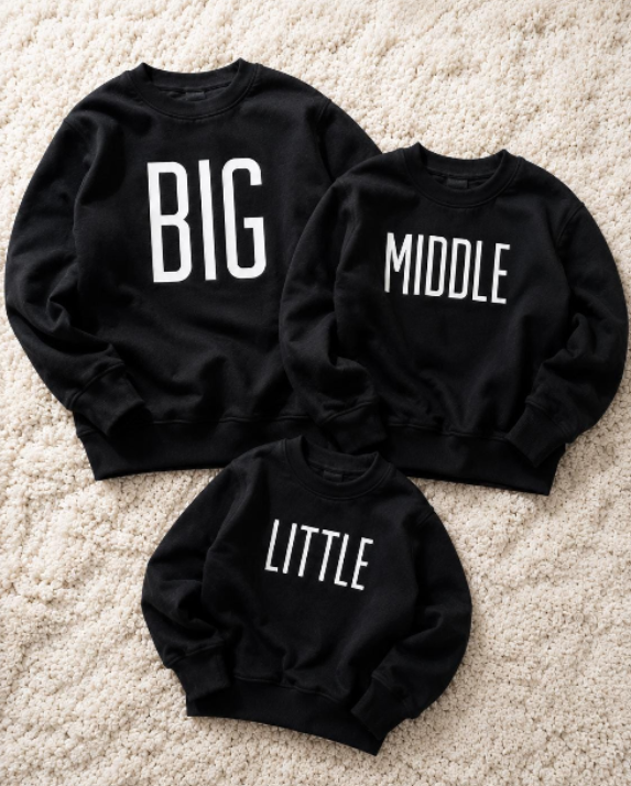 black jumper with big, middle and little print