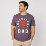 Man wearing a mauve t-shirt with a graphic and text 'The Coolest Dad" and an image of red popsicle on a plain background