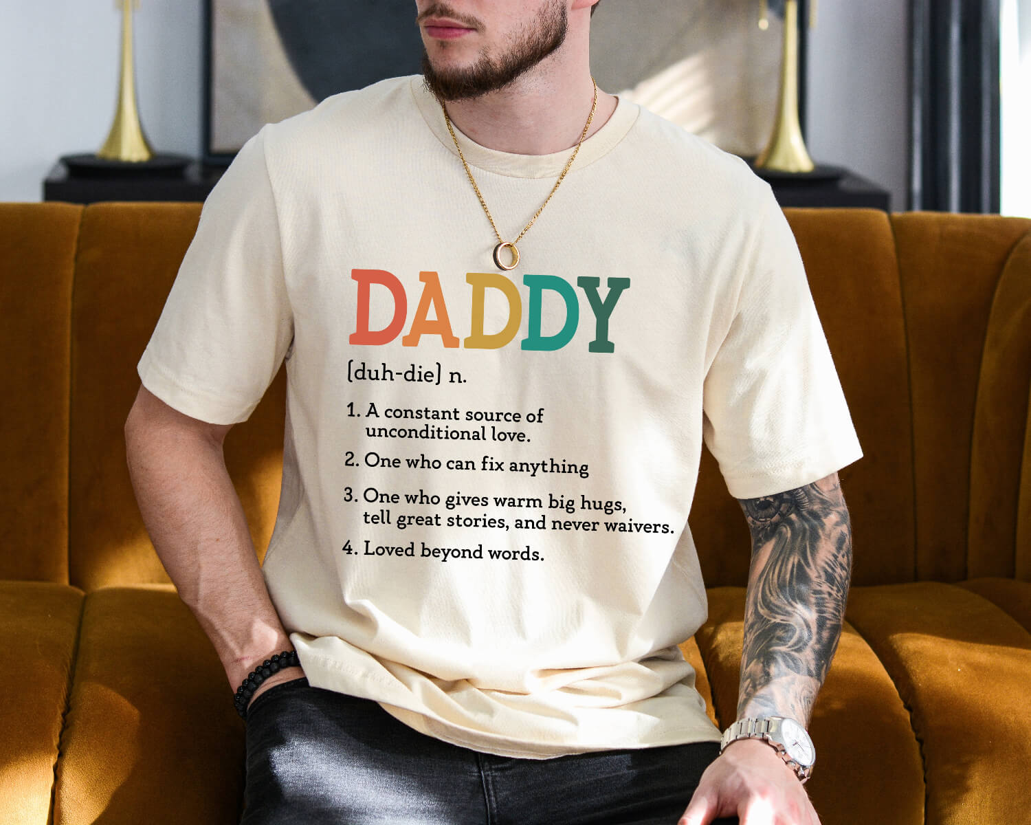 Dad wearing Daddy Definition Shirt while sitting in the sofa