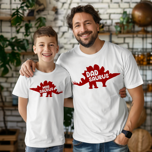 dad and son wearing a white shirt with a red dinosaur silhouette saying dad saurus and mini saurus
