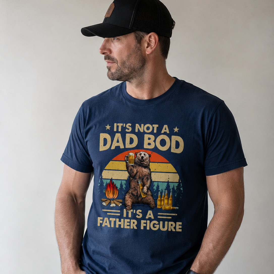 Man wearing a navy blue t-shirt with a graphic and text, standing against a plain background