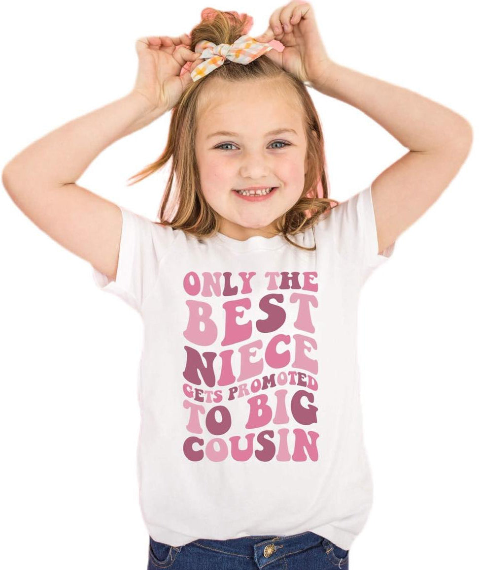 pretty girl wearing the Only the Best Niece Gets Promoted to Big Cousin shirt in white